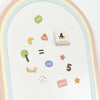 The Magnetic Number Play Set features a whiteboard with a pastel rainbow border, colorful magnetic shapes, number and word magnets like "week," "days," and "months," plus fun symbols such as a tree, star, and equal sign.