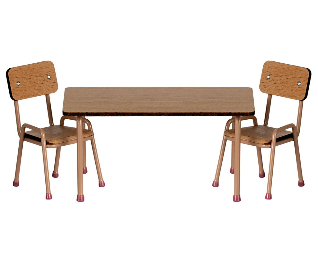 Two wooden chairs with metal legs flank a matching rectangular table from the Maileg After School Set. The chairs feature brown seats and backs, showcasing a simple, minimalist design.