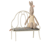 The Maileg Vintage Bench, Miniature - Off White features a blue floral cushion and is perfectly sized for any bunny or rabbit.