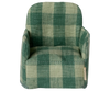 The Maileg Folding Chair, Mouse – Green Checker, features a cozy green checkered fabric and rounded arms. Seen from the front, its charming design is perfect for the Mouse hole Farmhouse.