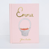 The "Emma | Collector's Edition | Hardcover" is a pale pink book with gold embossed text and a cover illustration of a white basket filled with red apples.