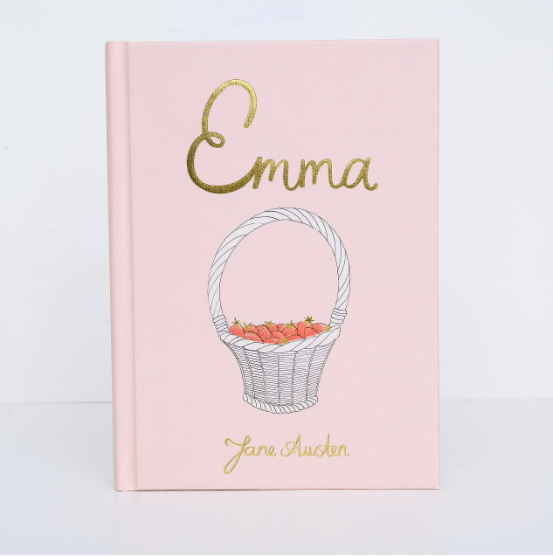 The "Emma | Collector's Edition | Hardcover" is a pale pink book with gold embossed text and a cover illustration of a white basket filled with red apples.