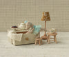 The Maileg Dance Mouse in Daybed, Little Sister - Mint wears a mint dress and lounges on her daybed, surrounded by miniature furniture and accessories for a charming, whimsical play scene.