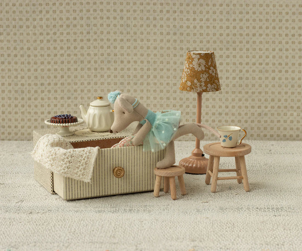 The Maileg Dance Mouse in Daybed, Little Sister - Mint wears a mint dress and lounges on her daybed, surrounded by miniature furniture and accessories for a charming, whimsical play scene.