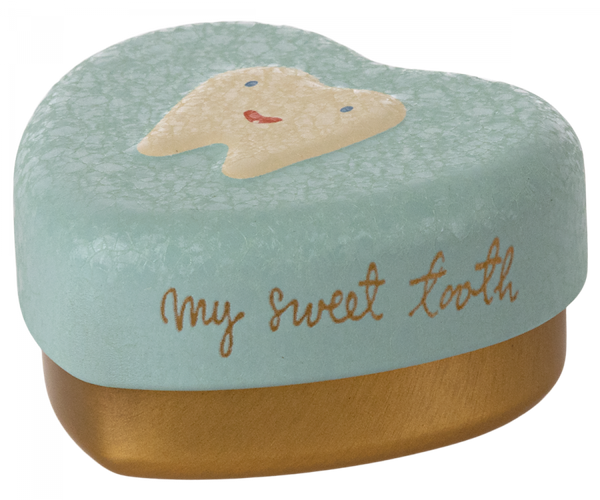 A Maileg Tooth Box with a pastel blue lid featuring a picture of a smiling tooth. The words "my sweet tooth" are written in cursive on the side of the lid. The bottom part of this metal heart keepsake is gold-colored, perfect for preserving precious childhood memories.