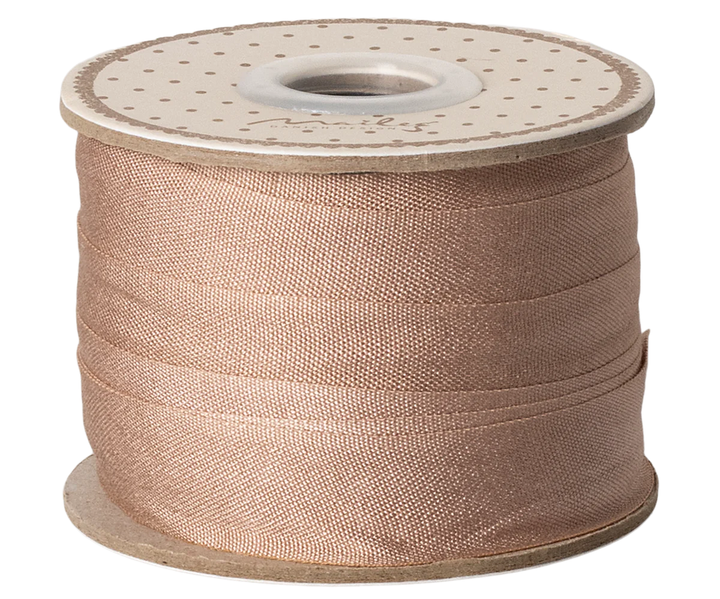 Maileg Ribbon - Soft Brown (10m) is a decorative spool of soft brown ribbon neatly wound on a cardboard reel with a white, polka-dotted top, perfect for giving any gift wrap an exclusive look.