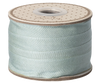 Maileg Ribbon - Dusty Mint (10m) is a light blue decorative ribbon on a polka-dotted reel, perfect for gift wrapping and giving any present an exclusive touch.