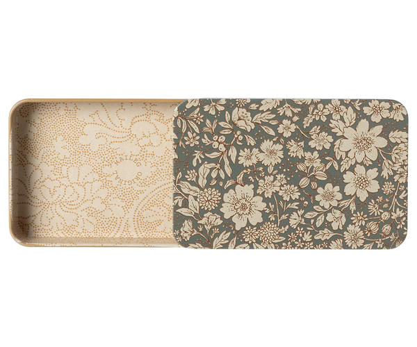 The Maileg Metal Box with Sliding Lid is a rectangular storage box adorned with an intricate floral pattern in beige and brown tones. The interior boasts a similar design with a lighter, more subtle floral motif. The lid is partially open, showcasing the inside pattern.