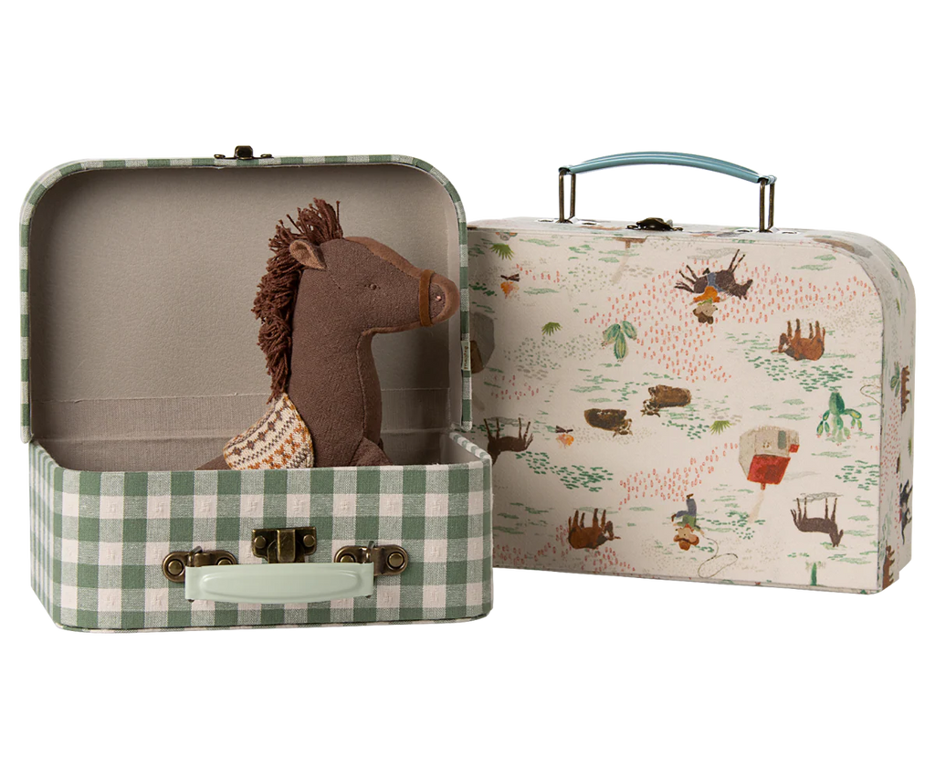 The Maileg Suitcase Set, 2-Pieces - Pony includes a green-and-white checkered suitcase with a toy horse and a second case featuring a countryside print. Both have light handles and metal clasps.