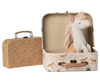 The Maileg Suitcase Set, 2-Pieces - Unicorn includes two vintage-style cases—one floral, one unicorn-themed. The unicorn suitcase opens to reveal a plush unicorn toy, ideal for adorable toy storage or display.