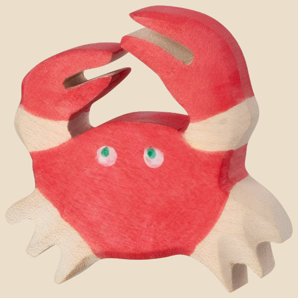 The Holztiger Crab is a handcrafted wood toy painted red and white with two raised claws and green eyes, carved in a playful style. Proudly made in Europe, it ships in one week as part of the charming HOLZTIGER figures collection.