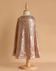 A child-sized mannequin showcases the Cape - Pink sequins against a plain beige background, with the sparkling pink costume draping elegantly from shoulders to mid-calf.