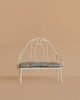 The Maileg Vintage Bench, Miniature - Off White features a decorative backrest and a light blue floral cushion, ideal for displaying Maileg bunnies or teddy bears against any background.