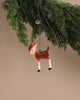 The Maileg Metal Bambi Deer Ornament, featuring white spots and a gold chain, hangs on a green pine branch against a beige background—ideal for Christmas tree décor or adding charm to your home.