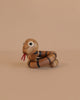 Spring Copenhagen The Snake is a wooden décor piece with big round eyes, black stripes, and a red tongue, coiled on beige—perfect as a spiritual gift or for celebrating the Chinese zodiac snake.