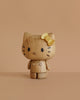 The Boyhood Hello Kitty 50th Anniversary Limited Edition is a wooden collectible with a yellow bow on its left ear, simple black features, and a smooth, rounded finish—perfect for fans of unique Hello Kitty figurines.