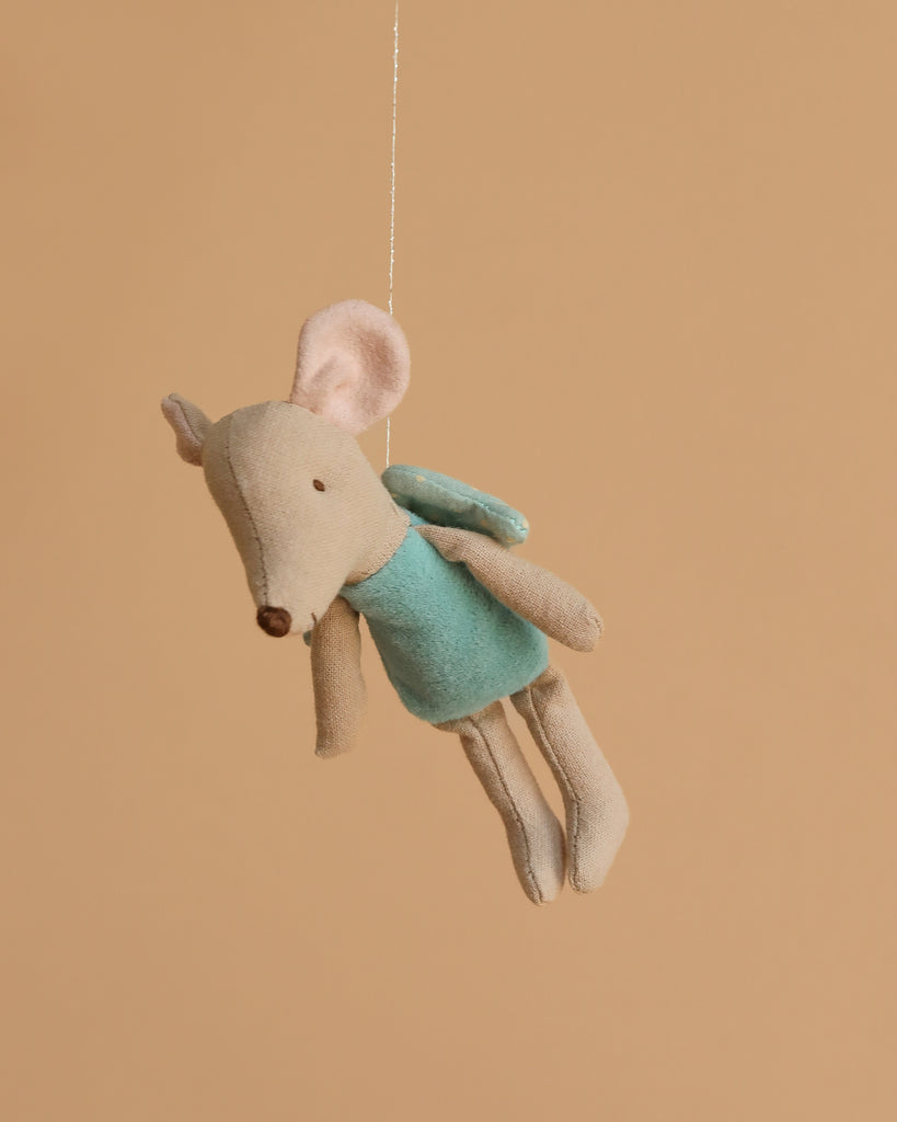 The Maileg Fairy Mouse, Little - Mint features a beige plush mouse with large pink ears, a mint outfit, and soft wings, hanging by a string against a light brown background—perfect for imaginative play.