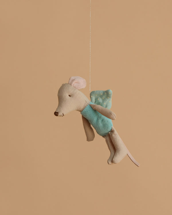 The Maileg Fairy Mouse, Little - Mint is a small plush dressed in a mint outfit with soft wings, hanging by a string against a plain beige background.