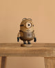 The Boyhood Minions Stuart, Small is a collectible figurine made from European FSC White Oak. It depicts one-eyed Stuart Minion with black gloves and hair, "STUART" inscribed on its base, and stands against a beige background.