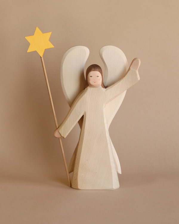 The Ostheimer Angel With Star - Large features a handcrafted wooden figurine with white wings, holding a yellow star on a stick. Inspired by classic Ostheimer toys, it’s ideal for imaginative play with its simple painted face and raised arm.