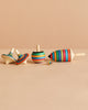 The Mader Spinning Top Champion Learning Set - Striped features five colorful, striped tops in various shapes and sizes—including an elongated one—neatly arranged on a beige surface; all meet toy safety standards to reduce choking hazard risks.