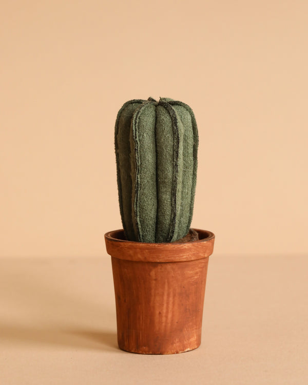 The Maileg Flower Pot With Cactus, Miniature features a green plush fabric cactus toy in a small flower pot, displayed against a plain beige background.