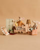 The Maileg Nursery Set With Mice features Mum Mouse and three baby triplets in a beige nursery with a crib, rocking chair, and dollhouse furniture, creating a warm and playful bedtime scene.