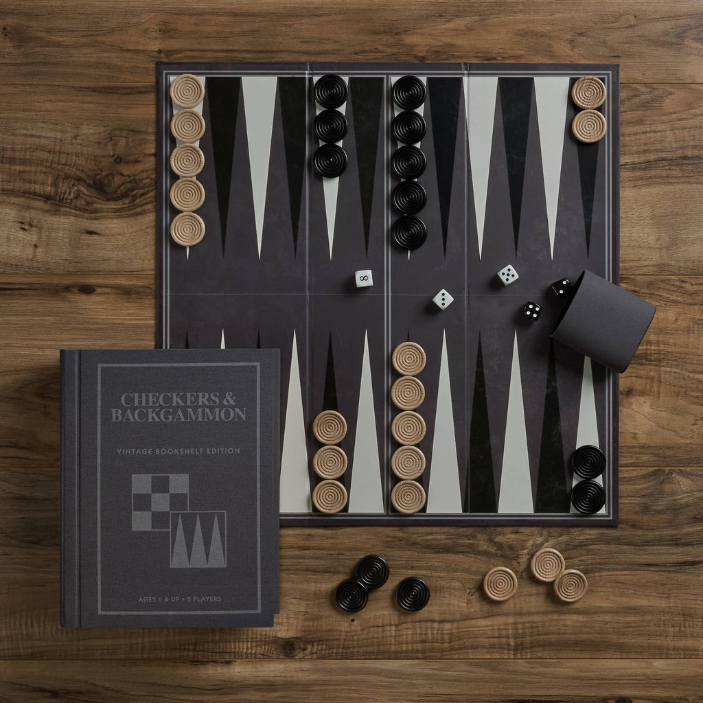 The Board Game: Checkers & Backgammon Vintage Bookshelf Edition, featuring black and beige pieces, dice, and a dice cup, sits on a wooden table—ideal for fans of classic board games.