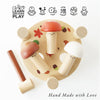 The Woodland Mushroom Hammer Game features three mushroom-shaped pegs (red, orange, white) in a round base, a small mallet, and icons for fine motor skills, logic, numeracy. Text: "Hand Made with Love.