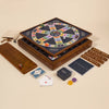 The 3-in-1 Game Collection features Scrabble tiles, Trivial Pursuit cards, classic playing pieces, and a wooden cribbage board with pegs—everything neatly arranged for hours of fun.