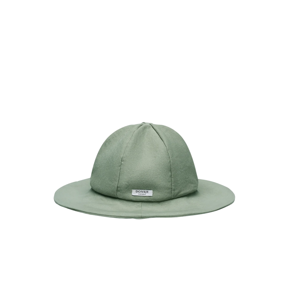The Donsje Organic Cotton Steijn Boat Hat in sage green features a wide brim for sun protection and a small rectangular "BONDI" label on the front, shown against a plain white background.