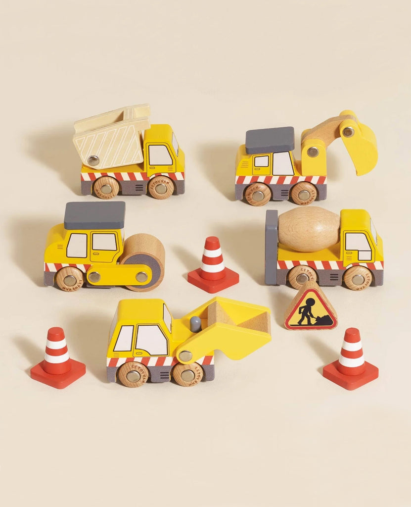 The Construction Toy Cars, Trucks & Diggers set (ships in one week) features a dump truck, excavator, road roller, and front loader with orange traffic cones and a roadwork sign for imaginative construction play on a light beige surface.