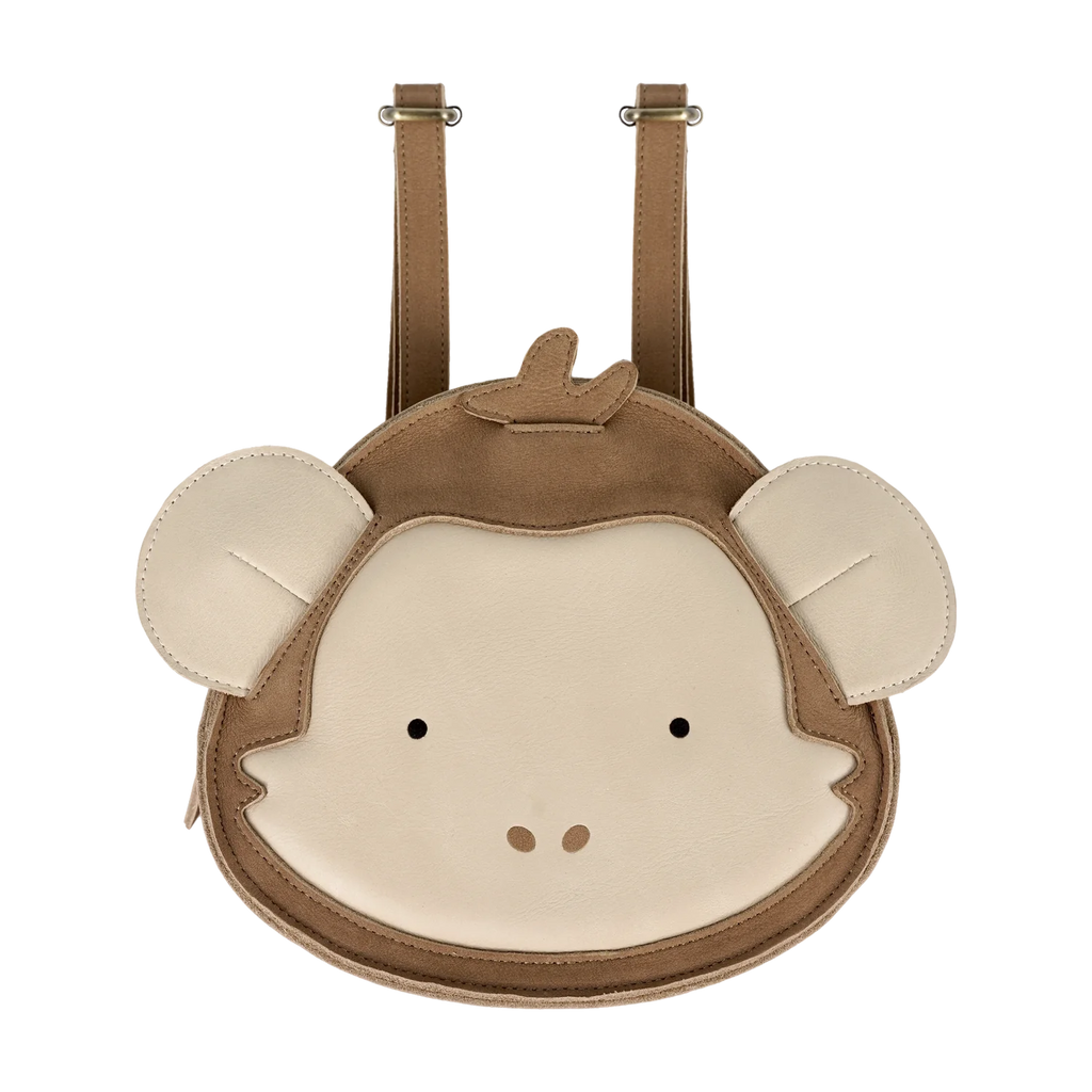 The Donsje Leather Kapi Backpack - Monkey is a small premium leather backpack in beige and brown, featuring a cartoon monkey face with round ears and simple facial features, inspired by the signature Donsje animal design.