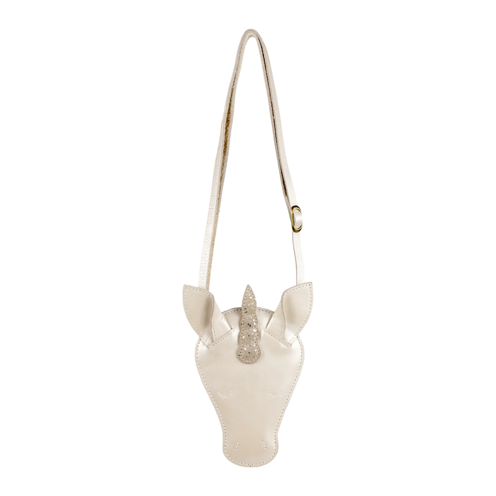 The Donsje Leather Blinc Purse - Unicorn is a cream-colored crossbody bag shaped like a unicorn's head, featuring pointed ears, a sparkly horn, and an adjustable leather strap inspired by Donsje's character design.