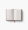 The Gracie Mini Embroidered Journal is an open mini hardcover with blank cream-colored pages and a red ribbon bookmark, displayed flat on a white background.