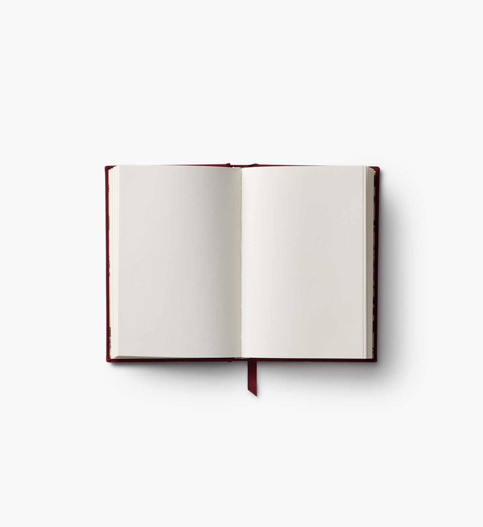 The Gracie Mini Embroidered Journal is an open mini hardcover with blank cream-colored pages and a red ribbon bookmark, displayed flat on a white background.