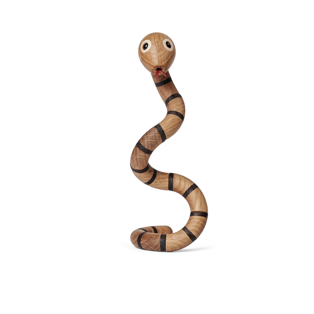 Spring Copenhagen The Snake is a wooden snake toy with a coiled, bendable body, painted black stripes, big round eyes, and a red mouth—ideal as unique wooden décor or a gift for anyone born in the Chinese zodiac snake year.