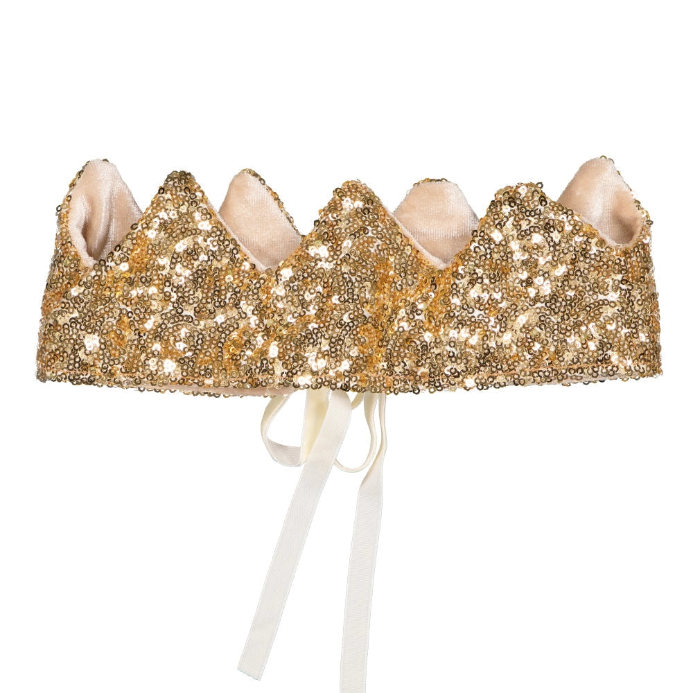 The Crown - Gold Sequins features a sparkly, scalloped gold design covered in sequins, lined with soft fabric. Created by Luciole et Petit Pois in France, it has white ribbon ties at the back for a secure fit.