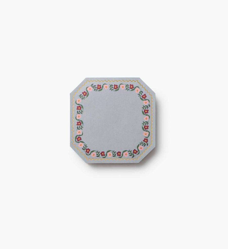 The Gemma Mini Notepad Trio features light blue covers with an octagonal design, a decorative border of pink and red flowers with green leaves on white, and metallic gold details, shown against a plain white background.