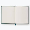 The Strawberry Fields Embroidered Sketchbook is an open hardcover journal with blank white pages and a blue ribbon bookmark, viewed from above on a plain white background.