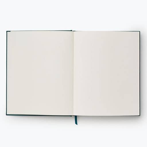 The Strawberry Fields Embroidered Sketchbook is an open hardcover journal with blank white pages and a blue ribbon bookmark, viewed from above on a plain white background.