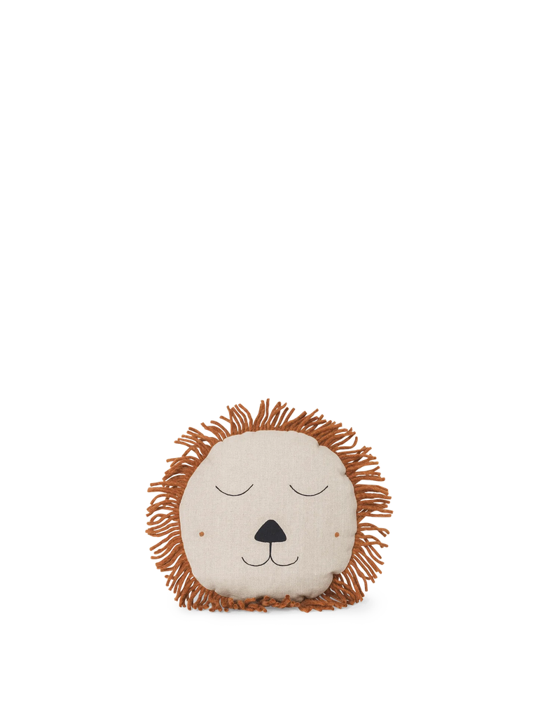The Ferm Living Safari Cushion - Lion is a round, beige linen cushion with a brown yarn mane and a simple, closed-eye lion face—ideal for adding cute charm to kids’ room decor.