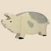 The Holtztiger Boar, handcrafted from maple and beech wood with a light cream body, gray markings, heart-shaped spot, black hooves, and a simple face—classic HOLZTIGER—ships in one week. Shown against a beige background.