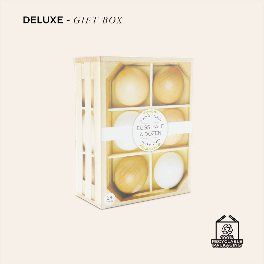 The Farm Eggs Wooden Market Crate features six wooden farm eggs in a carton labeled “Eggs Half a Dozen.” The light-colored, 100% recyclable packaging is ideal for pretend play or as a charming wooden toy crate.