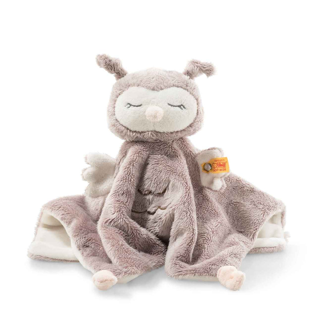 The Steiff Ollie Owl Baby Comforter, 10 inches, is a plush, handcrafted security blanket featuring a soft light brown body, cream face with closed eyes, small wings, side tag, and a cozy textured finish.