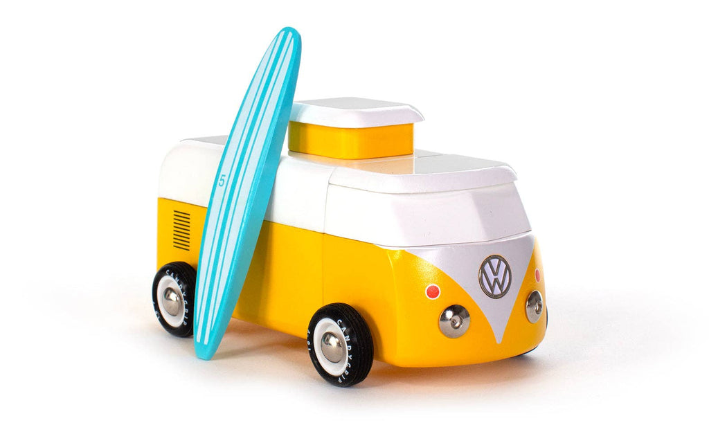 The VW Beach Bus Sunset is a yellow and white toy van inspired by a Volkswagen Type 2, featuring a blue surfboard on its side, displayed against a white background.