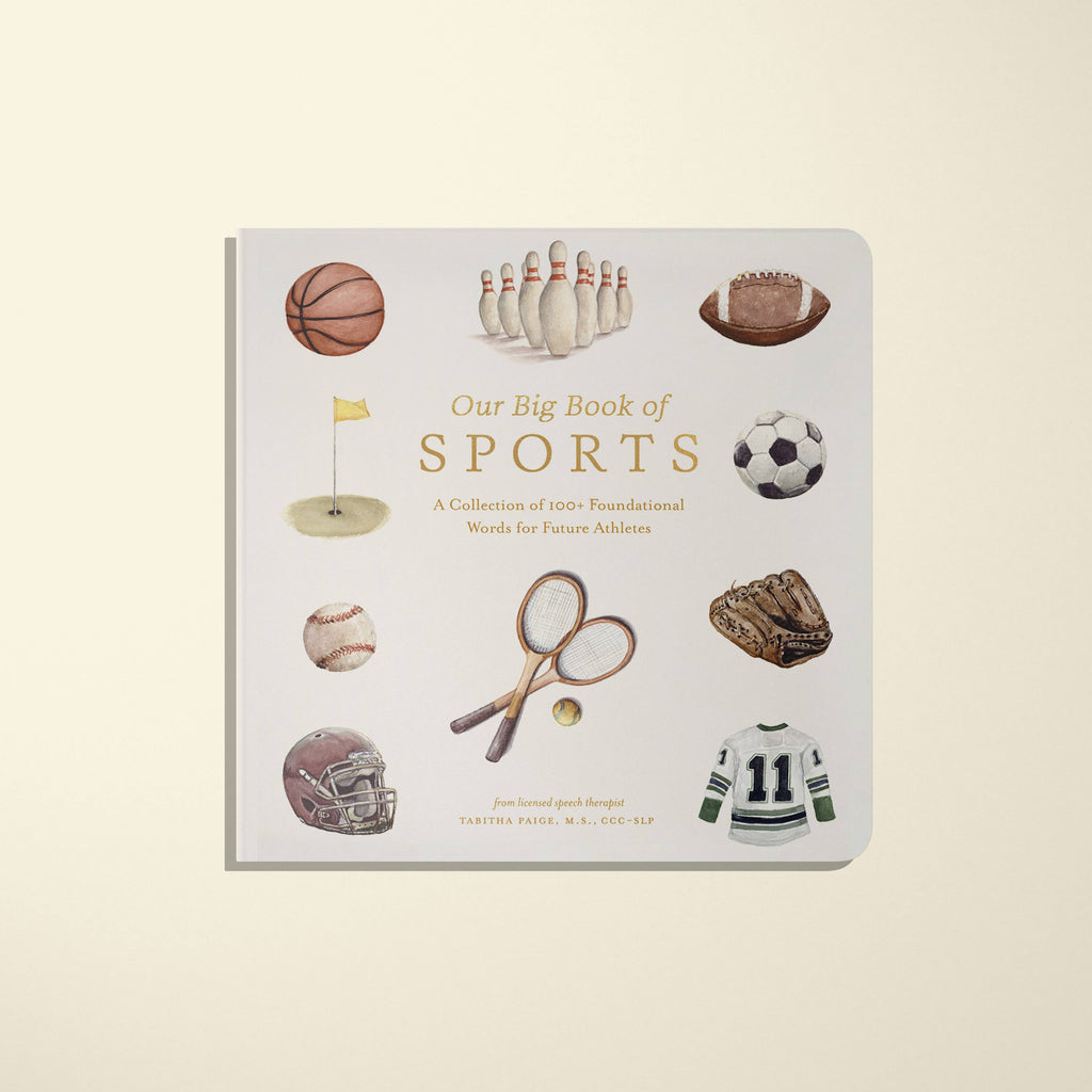 The "Newborn Gift Set" features a Maileg Teddy in a sporty organic cotton romper and a handmade wooden rattle, all nestled among vibrant illustrations of sports equipment on the cover of the children's book "Our Big Book of Sports.