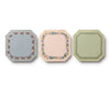 The Gemma Mini Notepad Trio includes three octagonal notepads with decorative floral and leafy borders in blue, pink, and green tones, accented with metallic gold details, displayed side by side against a white background.