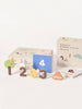 The Magnetic Number Play Set includes colorful numbers 1–4, an illustrated worm and rabbit, a "days" token, and two background boxes. These magnet pieces are arranged on a white surface for playful learning.