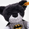 The Steiff Batman Teddy Bear, 12 Inches, features black and gray fur, a cape, and a yellow Batman logo on its chest. A signature yellow Steiff tag is attached to its ear—ideal for Dark Knight and DC Universe fans.